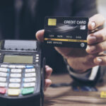 Merchant man's hand using credit card machine