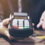 Merchant man's hand using credit card machine