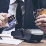 Merchant man's hand using credit card machine